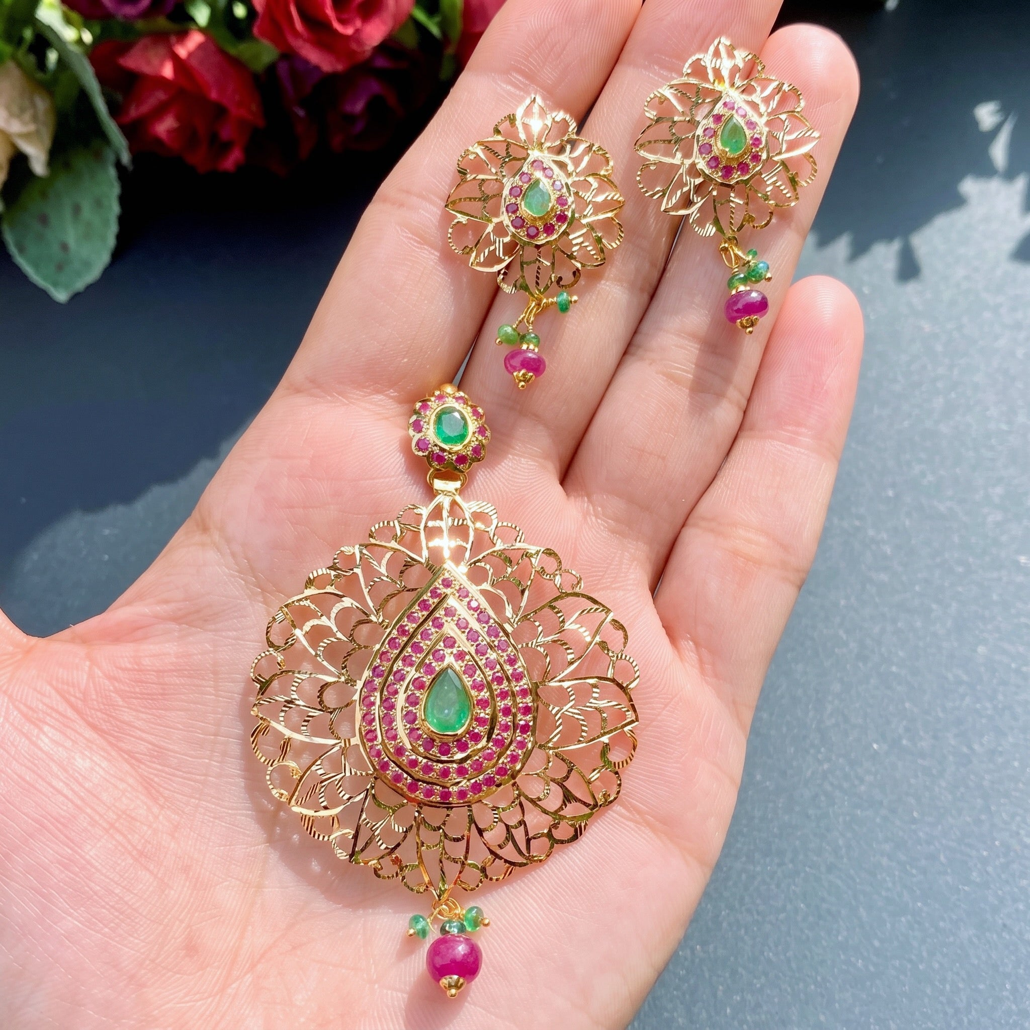 gold pendant set with ruby and emerald
