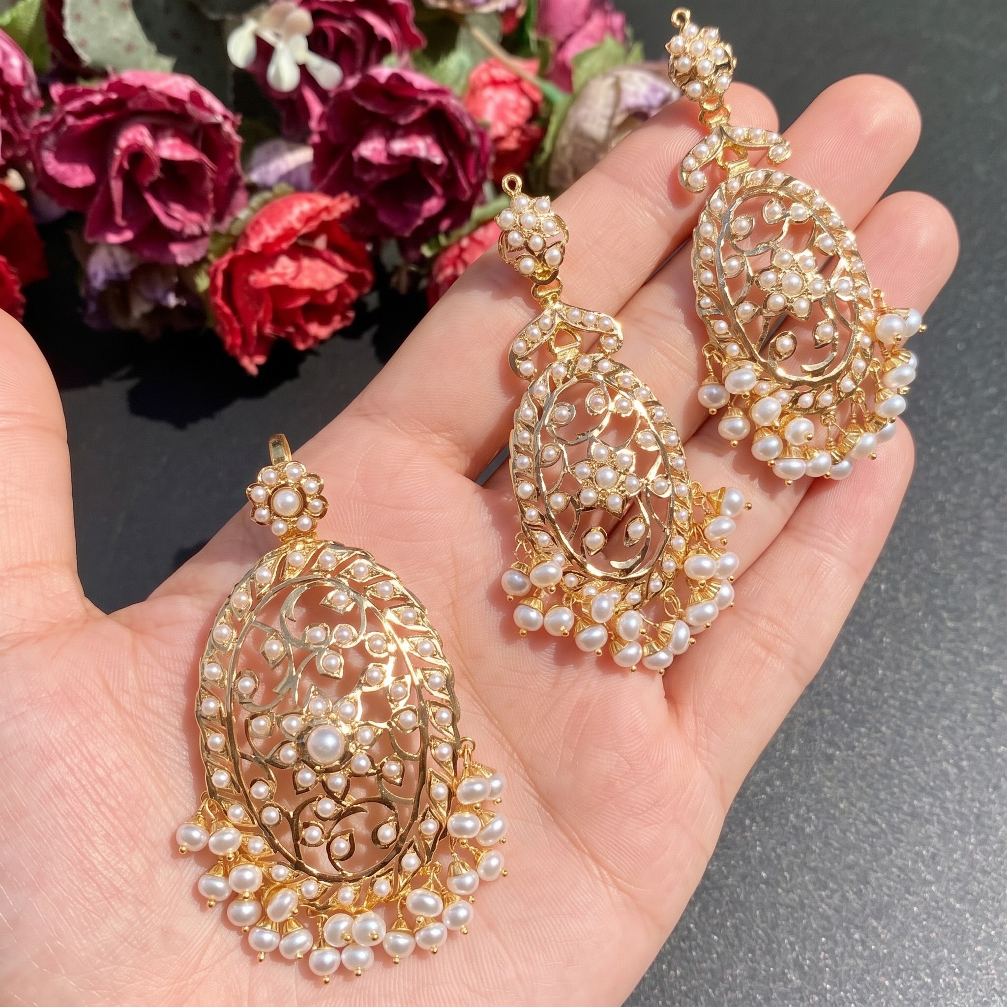 long gold pendant set studded with freshwater pearls