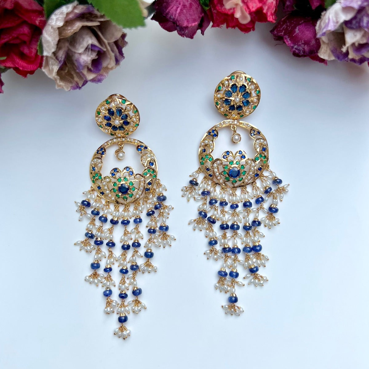 long chandbali earrings studded with pearls and blue sapphire and emeralds