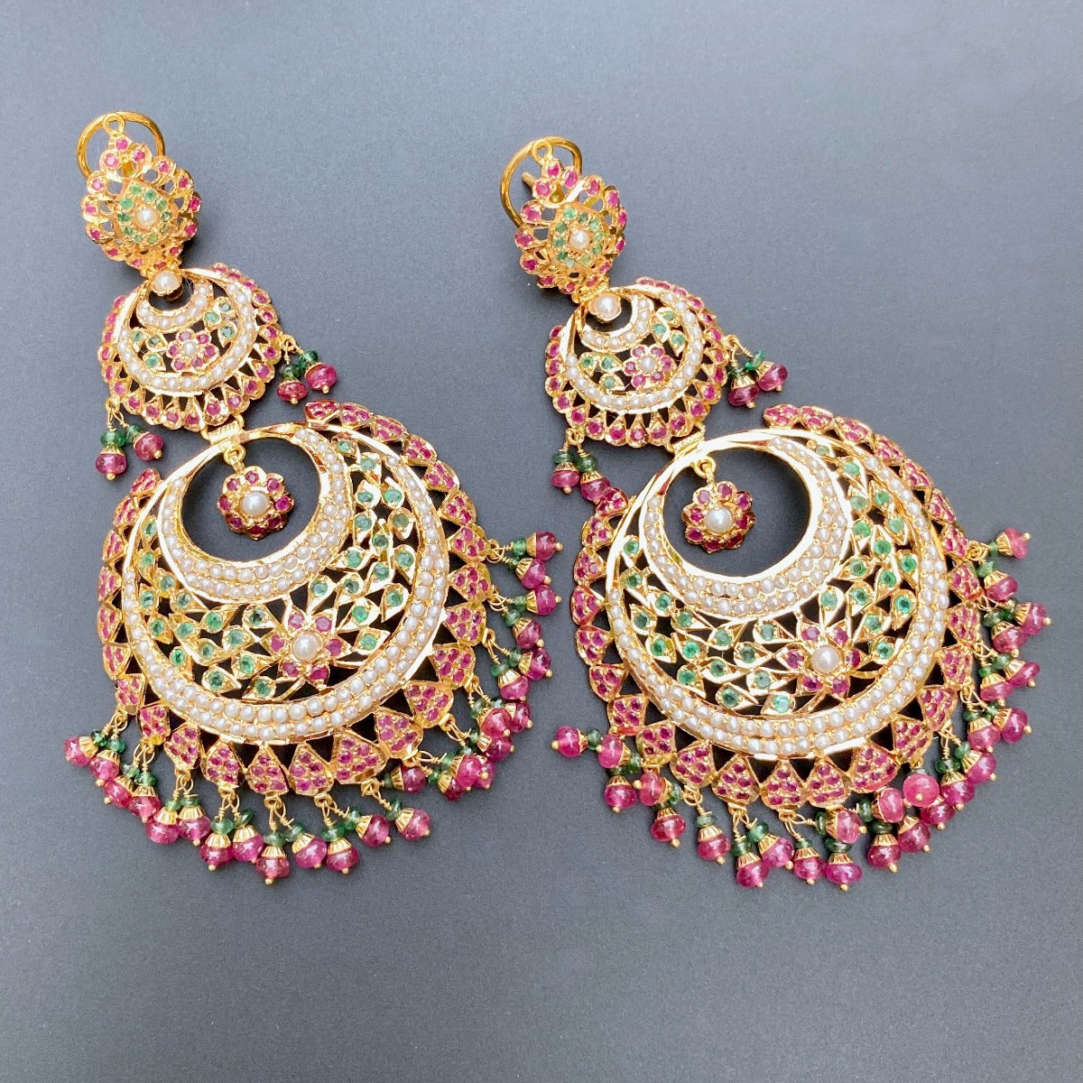 big chandbali jhumkas in gold studded with ruby emerald