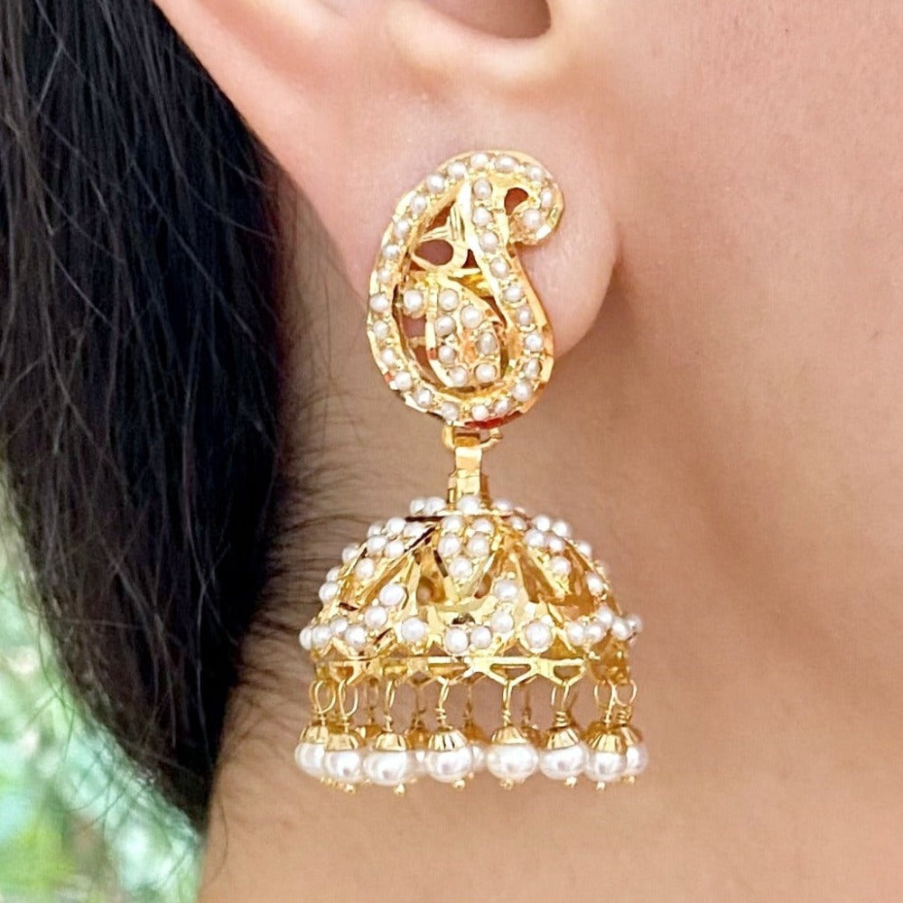 gold jhumka for women studded with freshwater pearl and made with the indian jadau technique