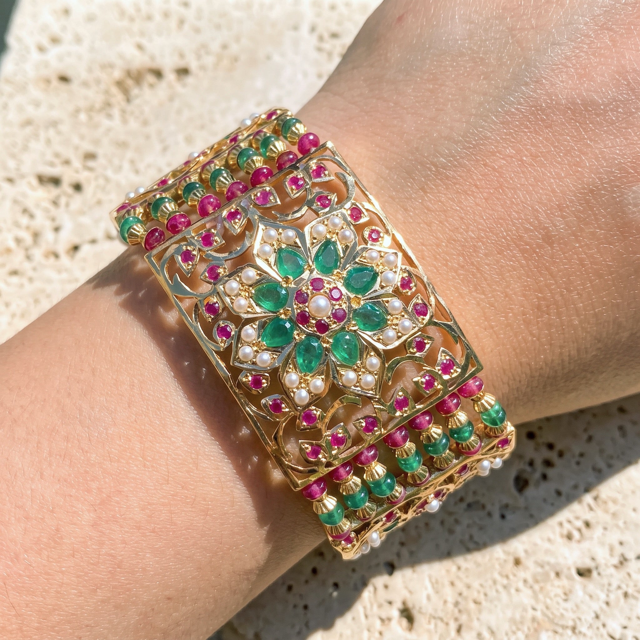 gold dasti bracelet studded with ruby emerald pearls for women in 22 carat gold
