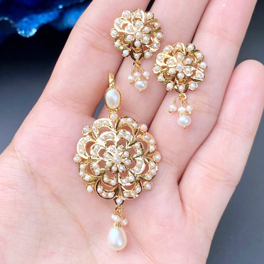 cute gold pendant set in pearls