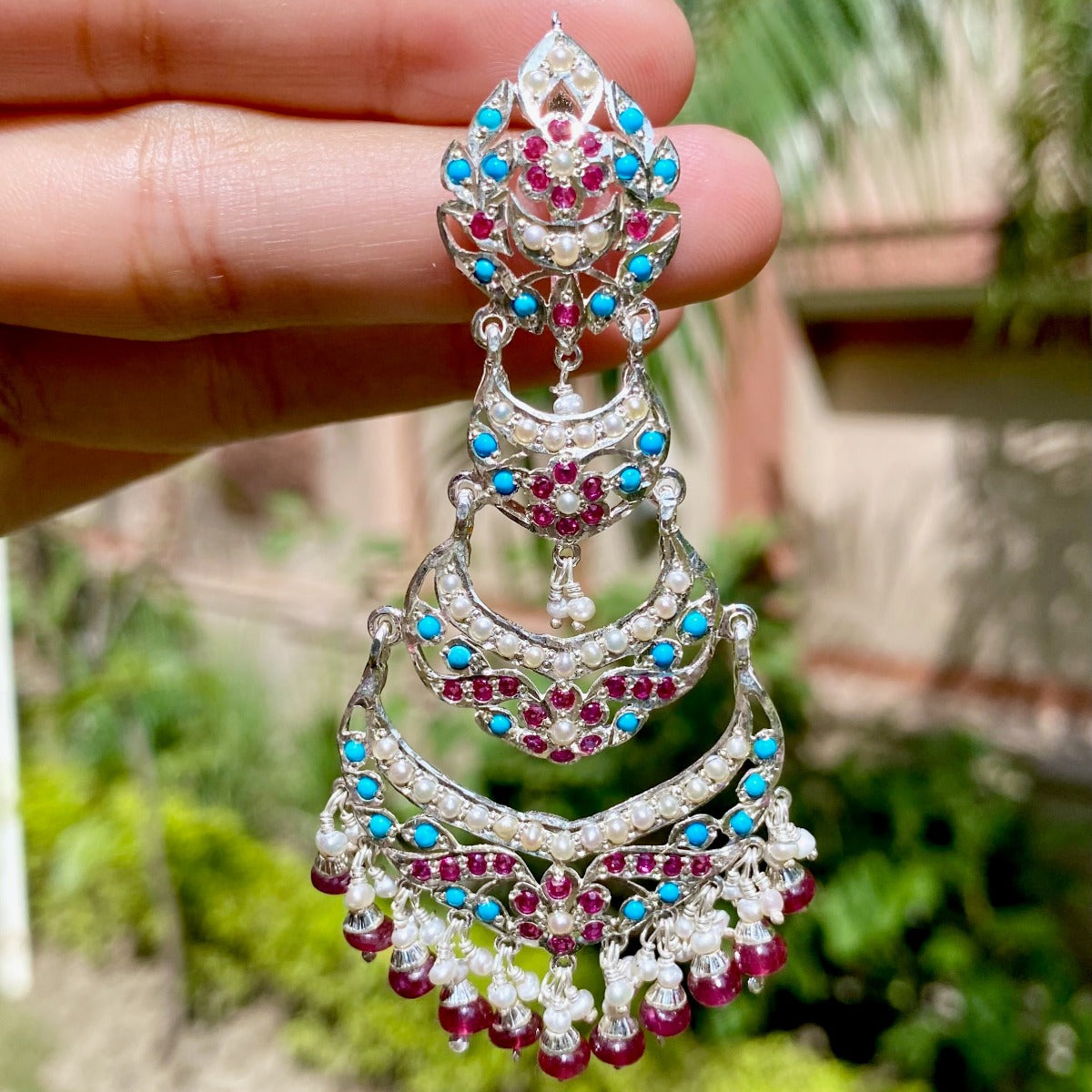 white silver earrings with blue and red stones