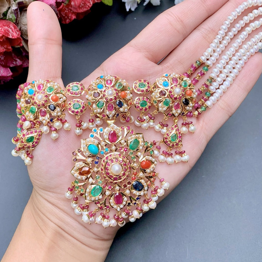 navratna necklace set for bride on 22k gold studded with precious natural stones. the design inspiration comes from malabar gold jewellers collection.