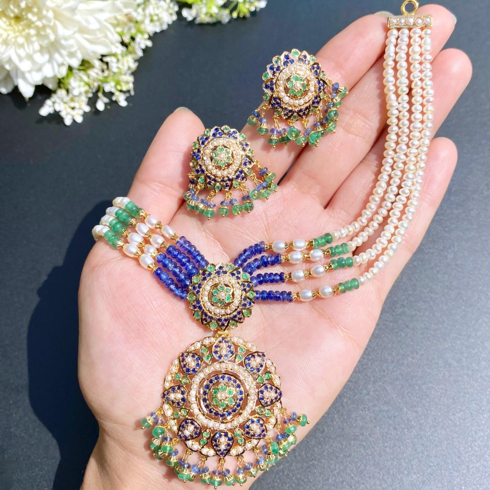 finely handcrafted indian jewelry studded with emeralds pearls and blue sapphire