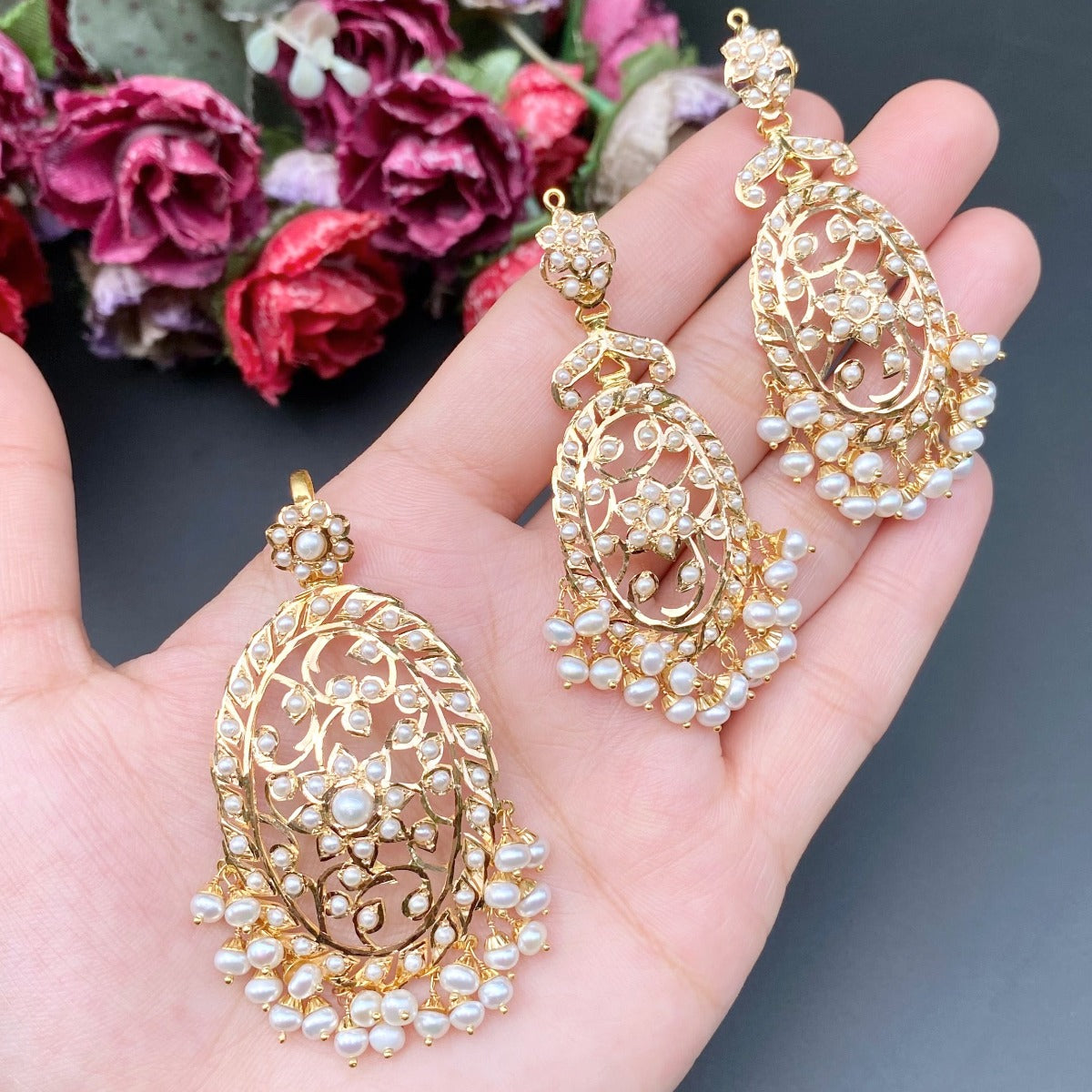 long gold pendant set studded with freshwater pearls